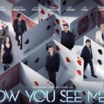 Promotional poster for Now You See Me 2, featuring the main cast including Jesse Eisenberg, Mark Ruffalo, Woody Harrelson, Dave Franco, Daniel Radcliffe, Lizzy Caplan, Jay Chou, Michael Caine, and Morgan Freeman, positioned within an intricate maze of oversized playing cards, conveying the film's magic and illusion theme.
