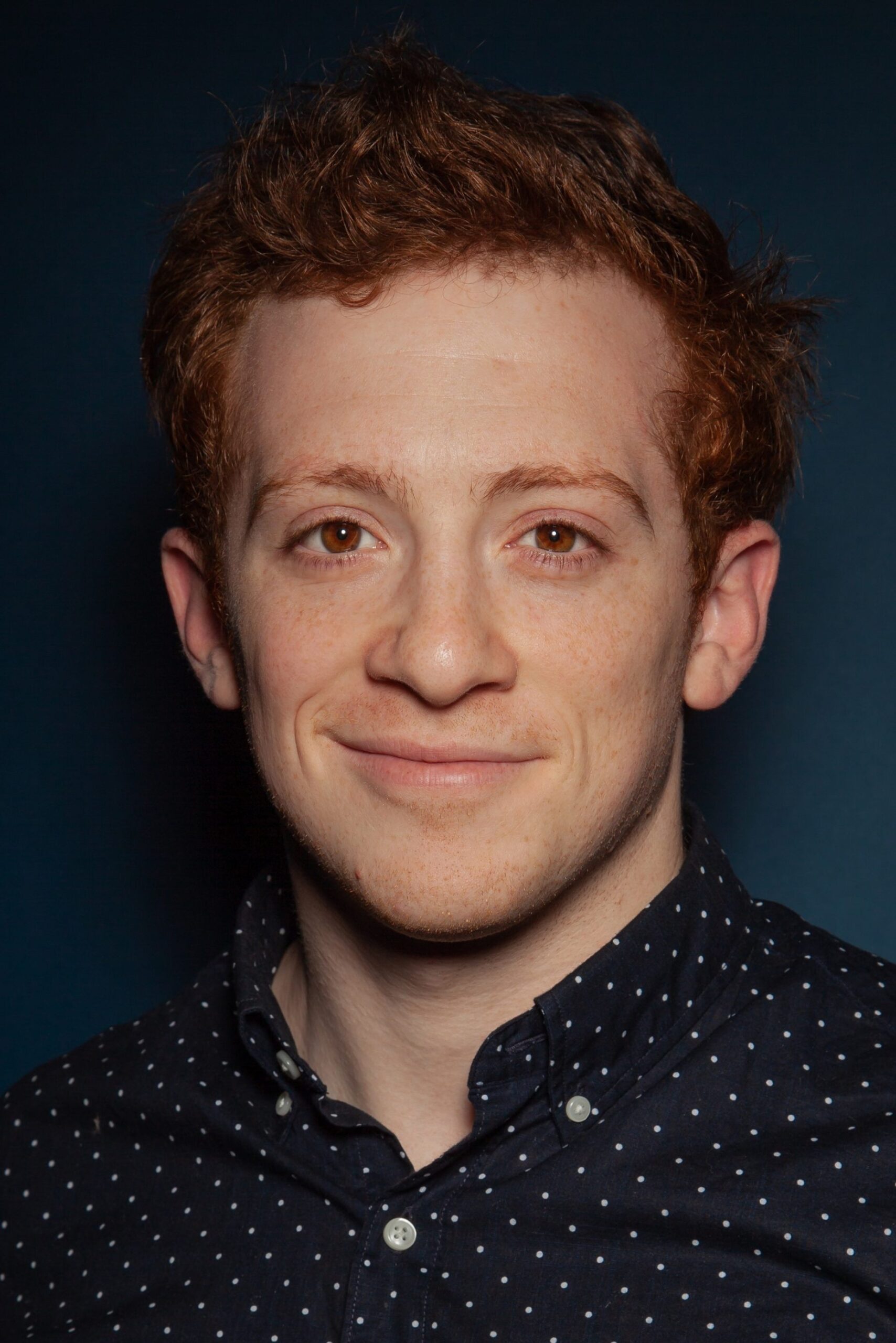 A headshot of Ethan Slater.