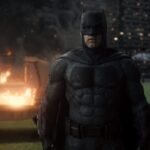 Ben Affleck's Batman in a dark, gritty scene with fire and destruction, embodying action and drama, not horror.