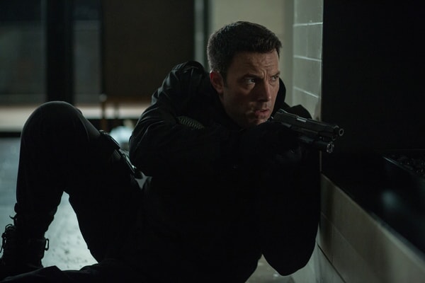 Christian Wolff (Ben Affleck) in a tense moment, likely mid-mission, showcasing his sharp focus in The Accountant.