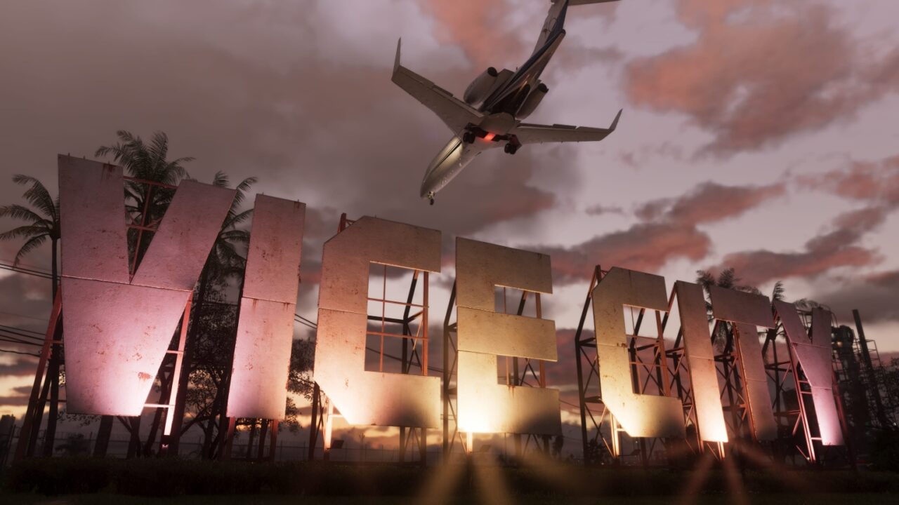 The large "VICE CITY" sign, reminiscent of the Hollywood sign, with a commercial airplane flying overhead at dusk.