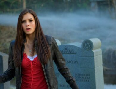 Nina Dobrev as Elena Gilbert in a cemetery with fog, looking surprised or startled.