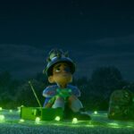 Elio, a young boy, sits on a rooftop at night surrounded by glowing green lights, looking up at the sky with a makeshift helmet, yearning for alien contact.