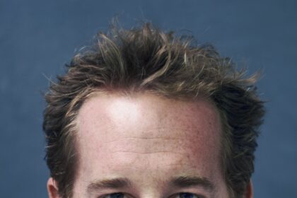 A headshot of Adam James.