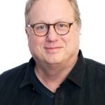 A headshot of Joel McNeely.