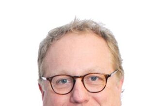 A headshot of Joel McNeely.