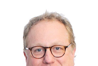 A headshot of Joel McNeely.