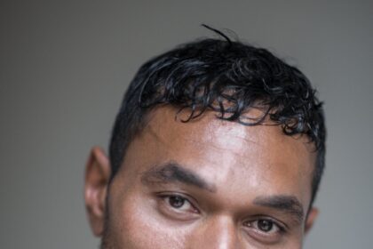 A headshot of CJ. Bloomfield.