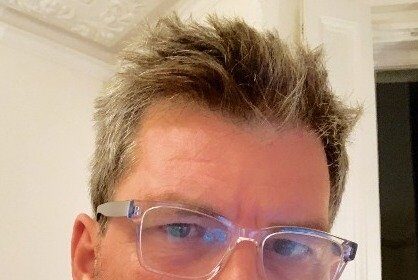 A headshot of Marcus Rowland.