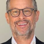 A headshot of James Thomas.