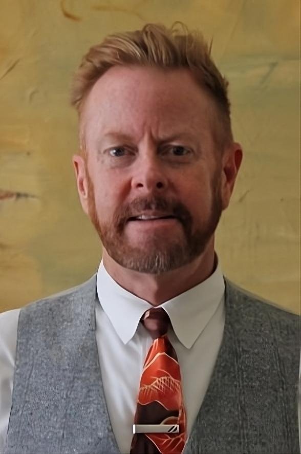 A headshot of Perry Andelin Blake.