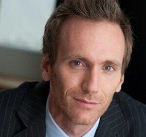 A headshot of Tom Carey.