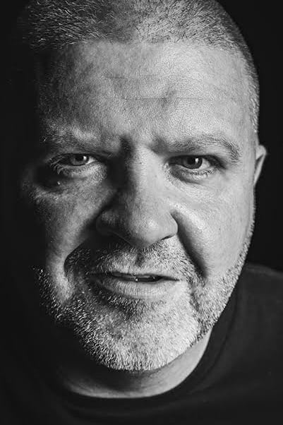 A headshot of George Carroll.