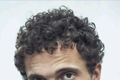 A headshot of Karl Glusman.