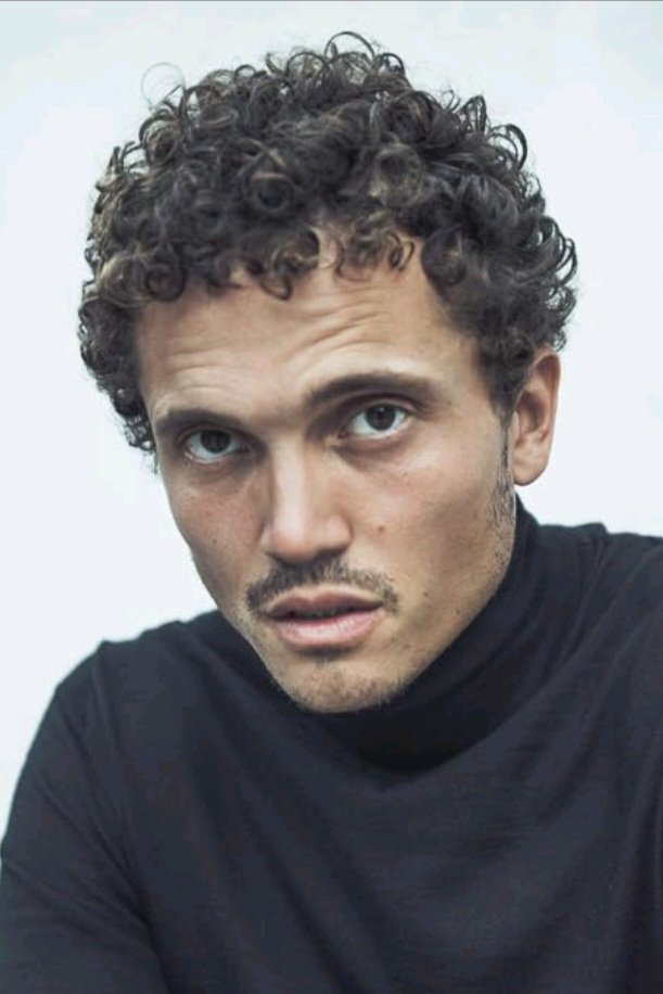 A headshot of Karl Glusman.