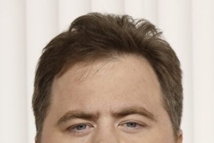 A headshot of Paul Walter Hauser.