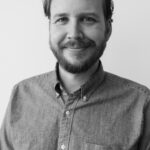 A headshot of Adam Hendricks.