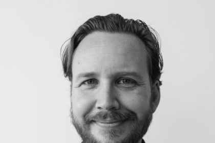 A headshot of Adam Hendricks.