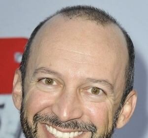 A headshot of J.P. Manoux.