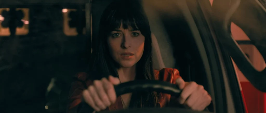 Cassie stole an ambulance and is driving through the chaos in Madame Web.